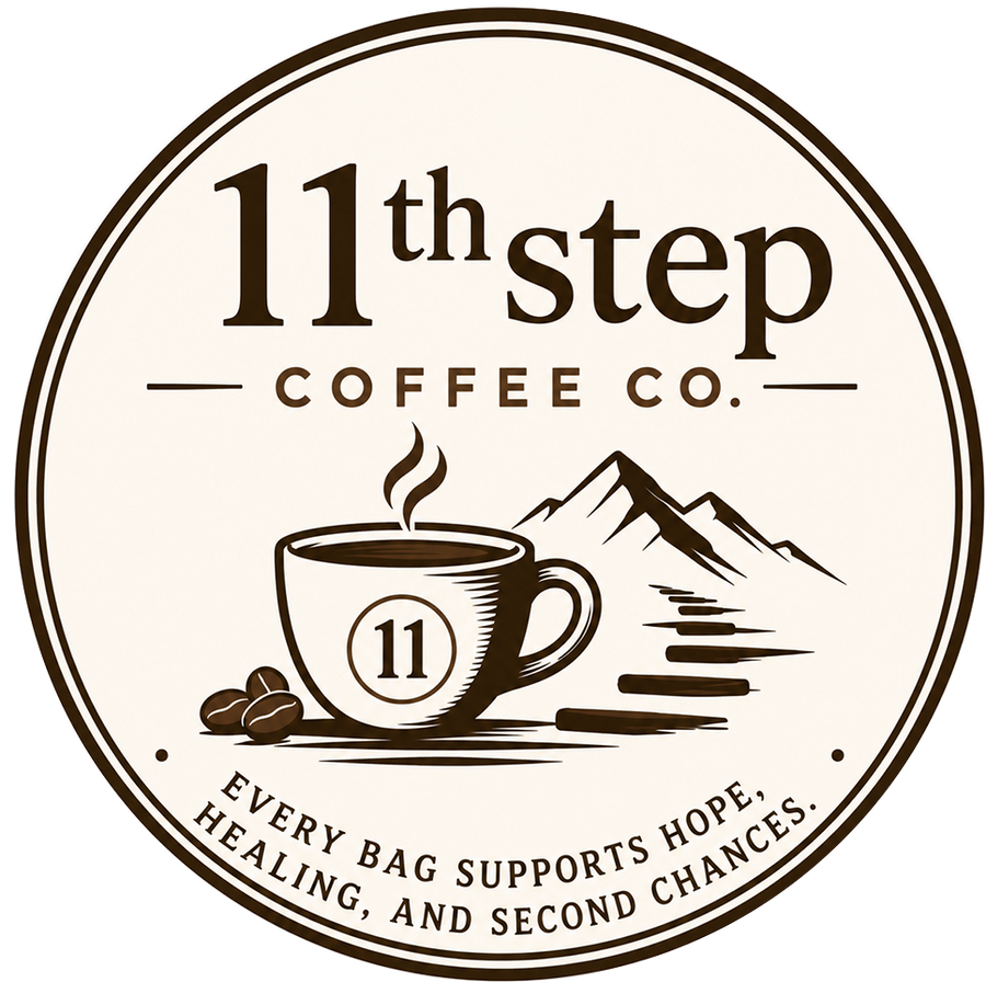 Logo for 11th Step Coffee Co. featuring a brown coffee cup with the number 11, coffee beans, mountains, and the slogan 'Every bag supports hope, healing, and second chances.